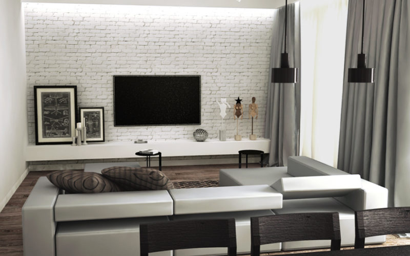 Salon w stylu Industrialnym, czarne lampy, biała industrialna cegła na ścianie, szary wygodny, w prostej formie wypoczynek, szafka RTV w kolorze białym